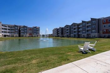 Large pond with a fountain in front of Promenade Luxury Apartments in Beaumont, Texas